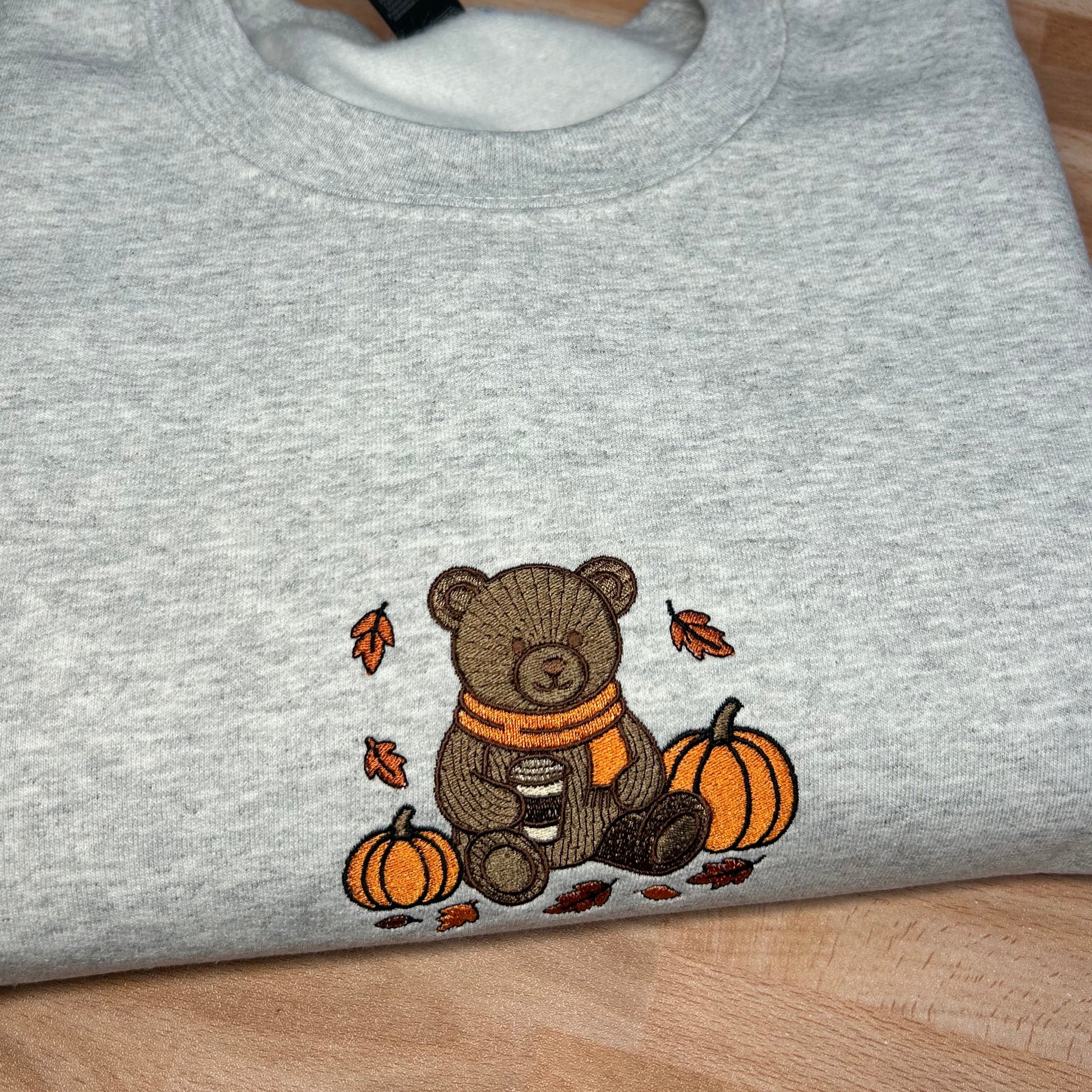 Gray embroidered sweatshirt with a teddy bear and fall pumpkin design